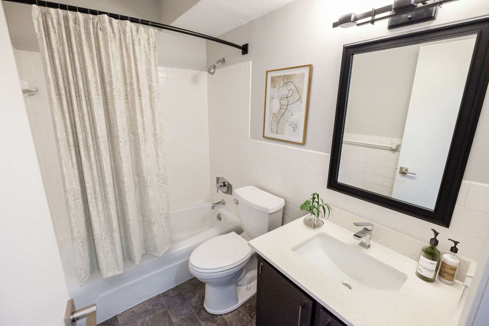 Modern finishes like subway tile and a framed mirror highlight the stylish life-style at The Concord. 