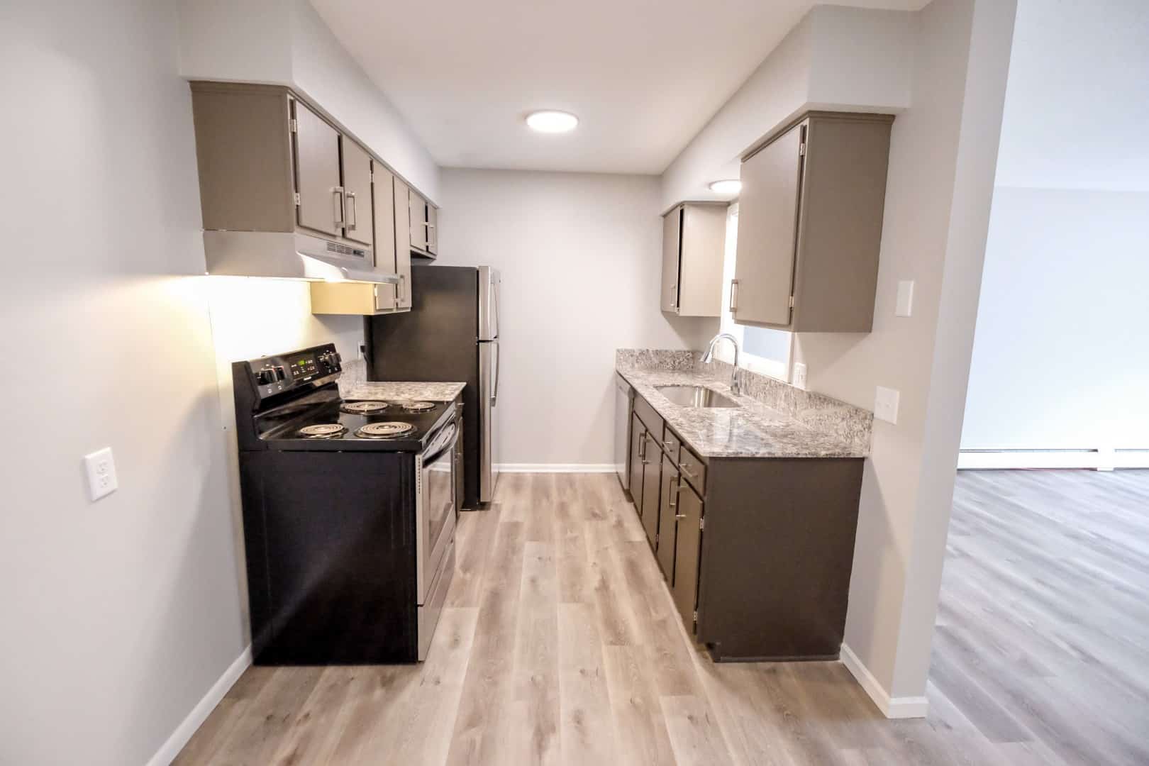 Kitchens equipped with granite countertops and wood flooring. 