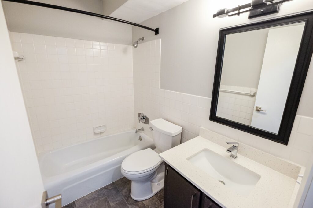 A bathroom at The Concord with a full shower and tub.